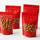 Transparent front and red back pouches filled with almonds